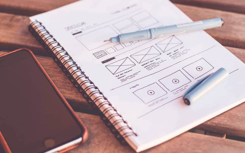 Design tools and UI mockups on a desk