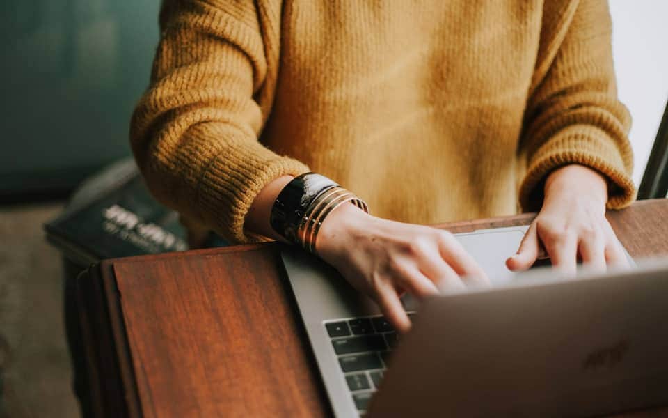 Hands typing on a laptop for IT support work